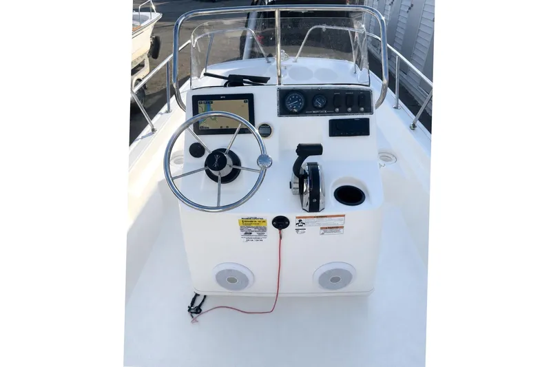 Slide: The Image of 2019 Boston Whaler 150 Montauk boat console with steering wheel and navigation controls. - 25