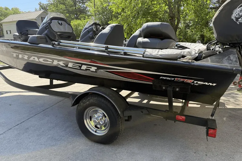 Slide: The Image of 2023 Tracker Pro Team 175 TX boat on trailer, parked outdoors. - 2