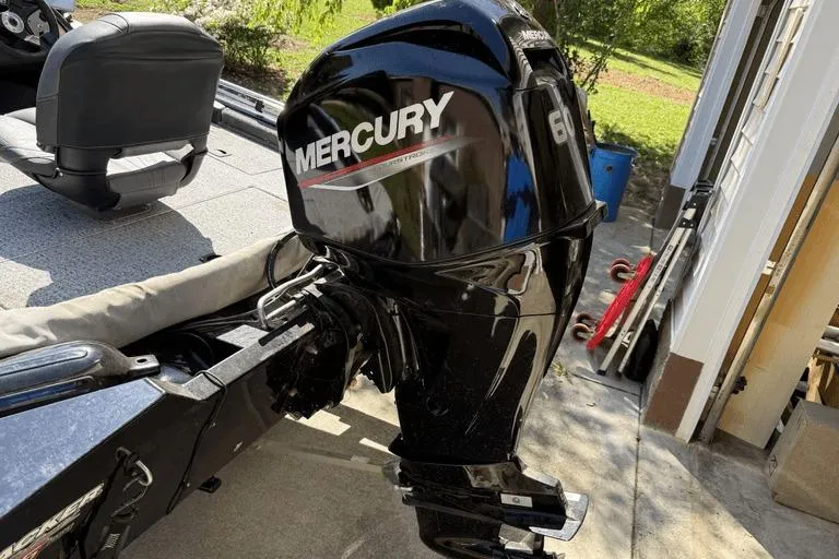 Slide: The Image of 2023 Tracker Pro Team 175 TX boat with Mercury 60 outboard motor in a driveway. - 4
