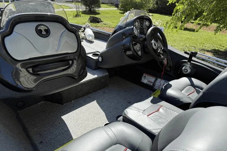 Slide: The Image of 2023 Tracker Pro Team 175 TX boat interior with steering console and seating. - 6