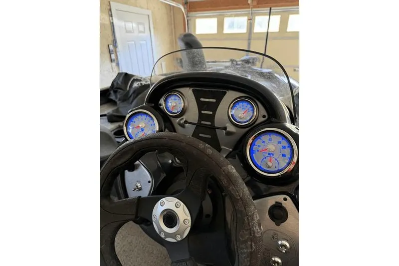 Slide: The Image of 2023 Tracker Pro Team 175 TX boat dashboard with gauges and steering wheel. - 7
