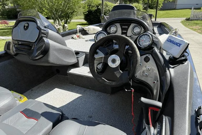 Slide: The Image of 2023 Tracker Pro Team 175 TX boat interior with steering wheel and dashboard controls. - 8