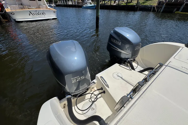 The Image of Twin Yamaha 225 outboard engines on a 2003 World Cat 270 EC boat in marina. - 0