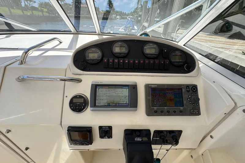 Slide: The Image of 2003 World Cat 270 EC boat dashboard with navigation and control instruments. - 11