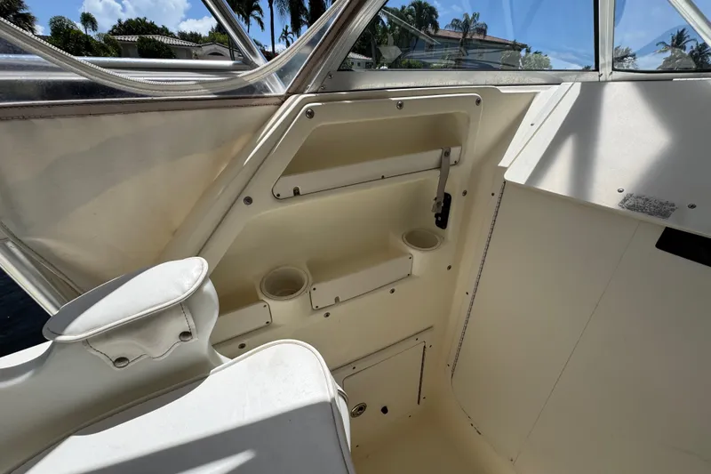 Slide: The Image of Interior view of a 2003 World Cat 270 EC boat, featuring seating and storage compartments. - 12