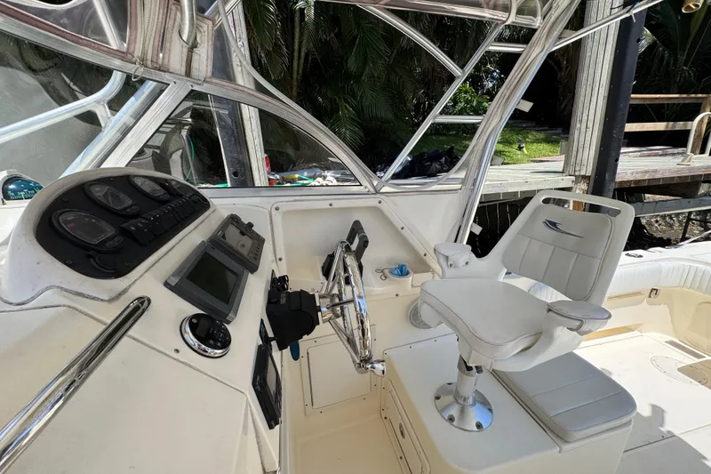 Slide: The Image of Helm of 2003 World Cat 270 EC boat with steering wheel and captain's chair. - 13