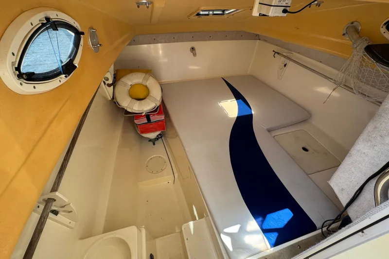 Slide: The Image of Interior cabin of a 2003 World Cat 270 EC boat with life preserver and seating. - 18