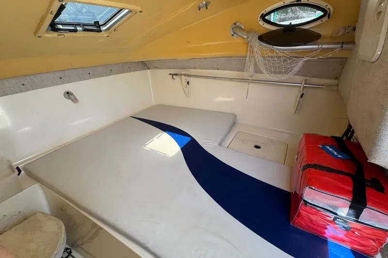 Slide: The Image of Interior cabin of 2003 World Cat 270 EC boat with cushions and storage. - 20