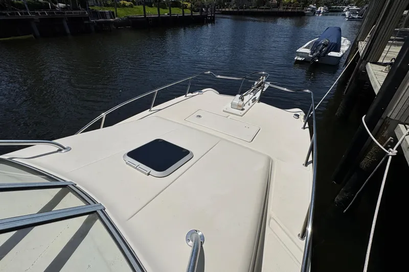 Slide: The Image of 2003 World Cat 270 EC boat docked, showcasing spacious deck and sleek design. - 28