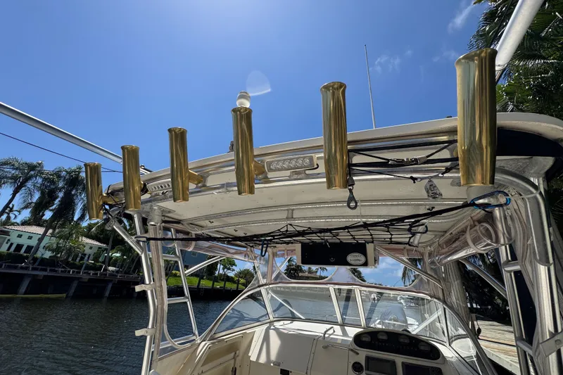Slide: The Image of 2003 World Cat 270 EC boat with rod holders under a clear blue sky. - 9