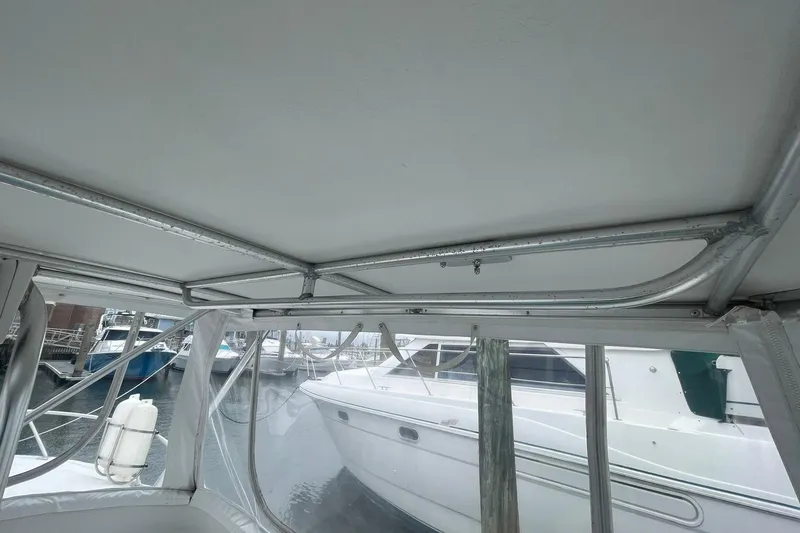 Slide: The Image of 1996 Luhrs Tournament 290 Open boat interior with metal frame and marina view. - 26