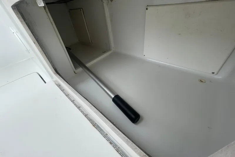 Slide: The Image of Storage compartment on a 1996 Luhrs Tournament 290 Open boat with a handle inside. - 29
