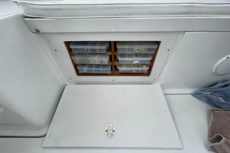 Slide: The Image of Storage compartment with tackle boxes on a 1996 Luhrs Tournament 290 Open boat. - 31