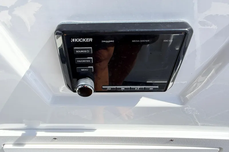 Slide: The Image of Kicker media center on a 2021 Tahoe 1950 boat dashboard. - 77