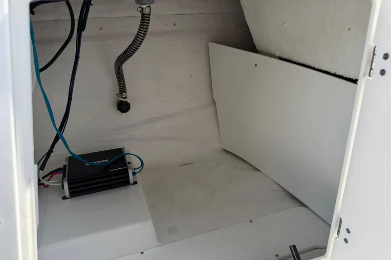 Slide: The Image of Interior of a 2021 Tahoe 1950 boat showing wiring and a Kicker amplifier. - 79