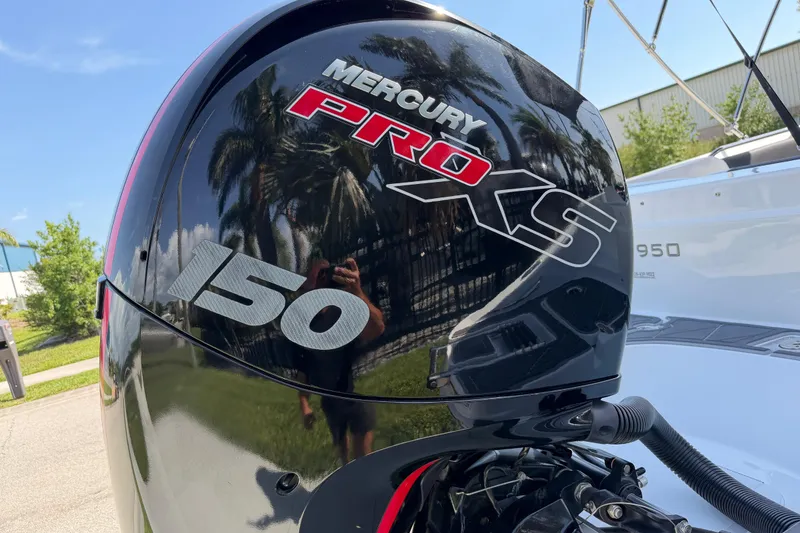 Slide: The Image of Mercury Pro XS 150 outboard motor on 2021 Tahoe 1950 boat, sunny day reflection. - 12