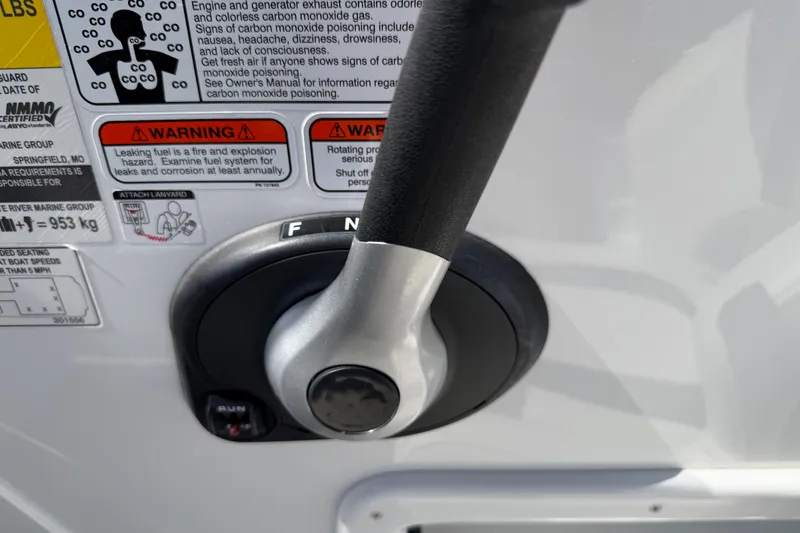 Slide: The Image of Control lever with warning labels on a 2021 Tahoe 1950 boat. - 41