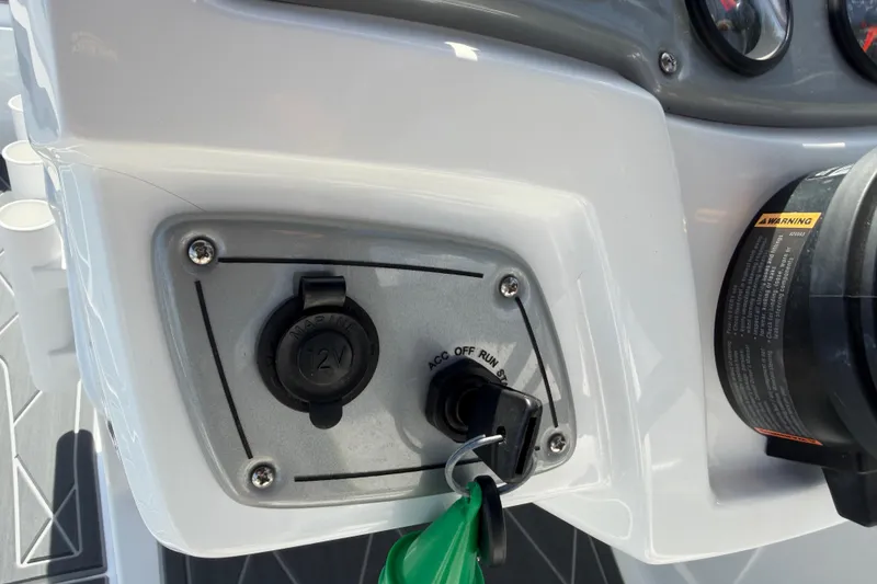 Slide: The Image of Dashboard of a 2021 Tahoe 1950 boat with ignition key and 12V outlet. - 49