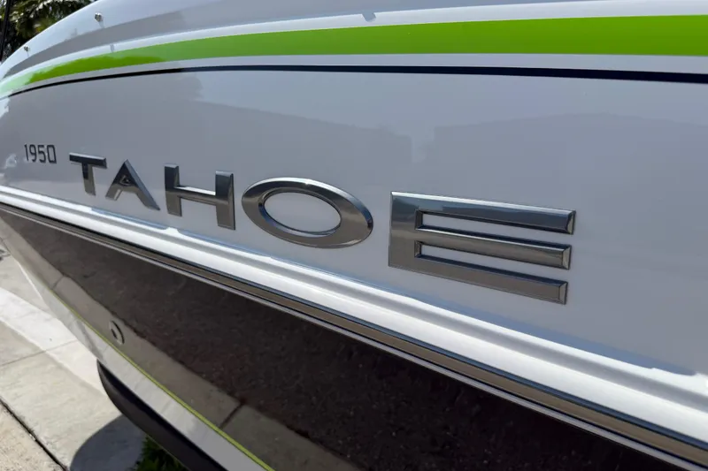 Slide: The Image of 2021 Tahoe 1950 boat with sleek design and green accent stripe. - 100