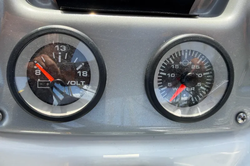 Slide: The Image of Dashboard gauges of a 2021 Tahoe 1950 boat, displaying voltage and water pressure. - 47