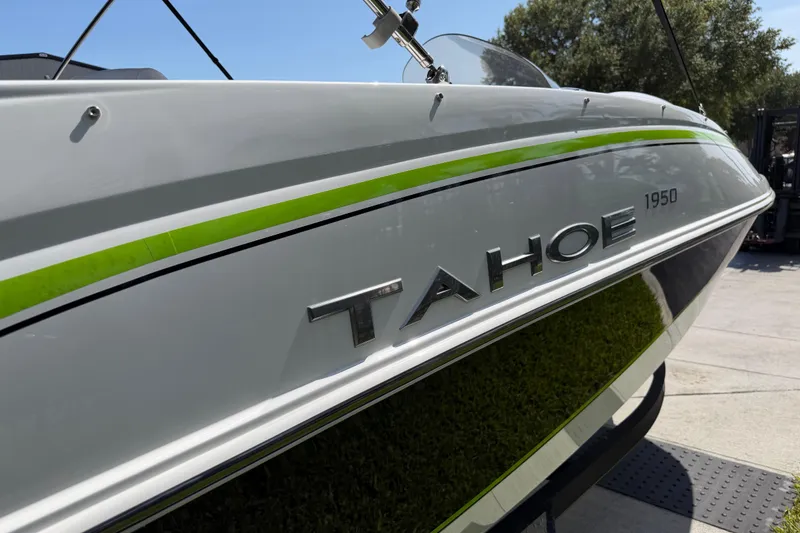 Slide: The Image of 2021 Tahoe 1950 boat with sleek design and green accent stripe. - 18