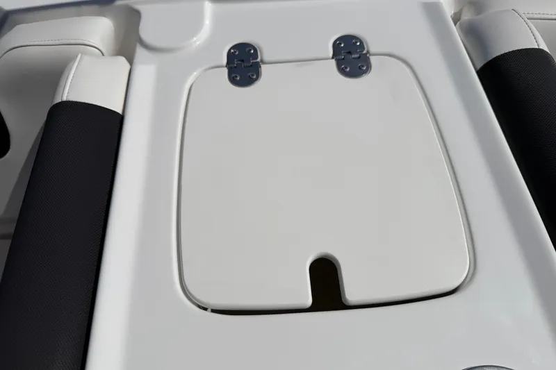 Slide: The Image of Hinged compartment on a 2021 Tahoe 1950 boat, featuring sleek white design. - 74
