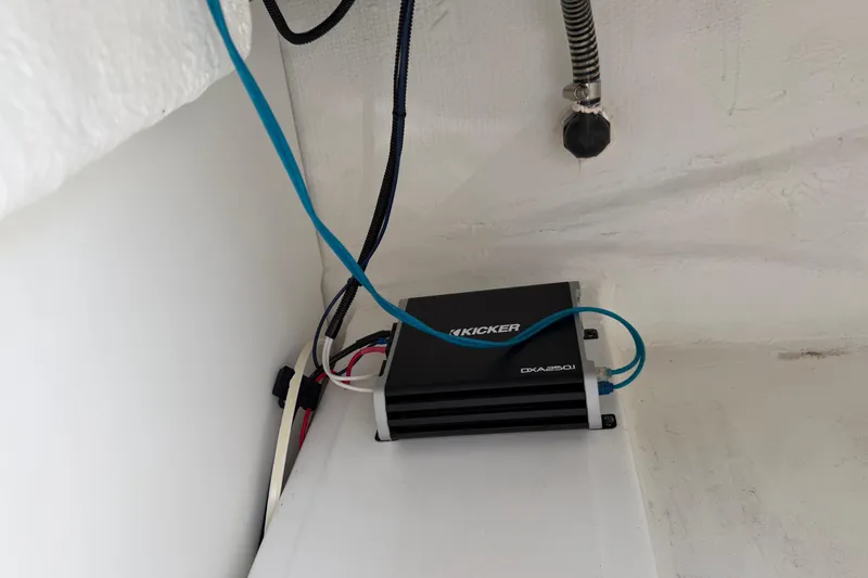 Slide: The Image of Audio amplifier installation in a 2021 Tahoe 1950 boat, featuring Kicker DXA250.1 model. - 81