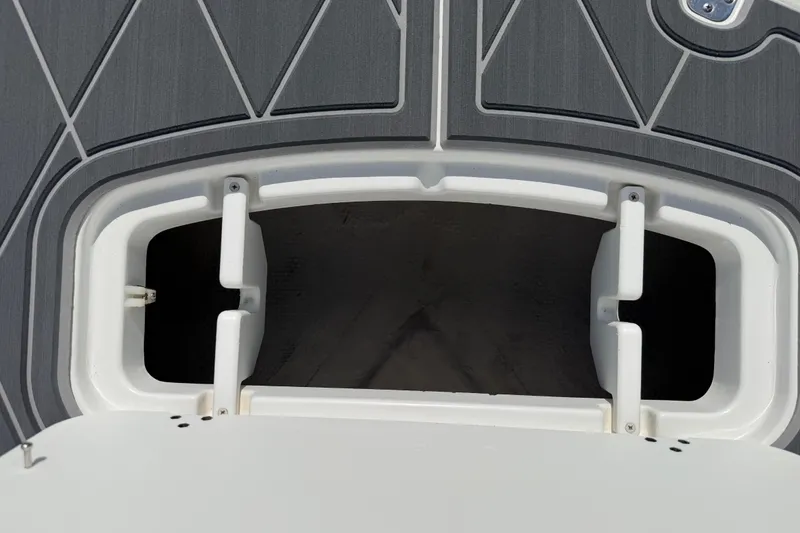 Slide: The Image of Open storage compartment on a 2021 Tahoe 1950 boat, featuring a sleek gray deck design. - 65