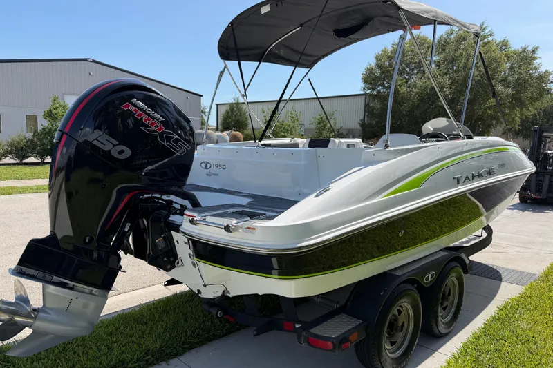 Slide: The Image of 2021 Tahoe 1950 boat with Mercury Pro XS engine on trailer, parked outdoors. - 15