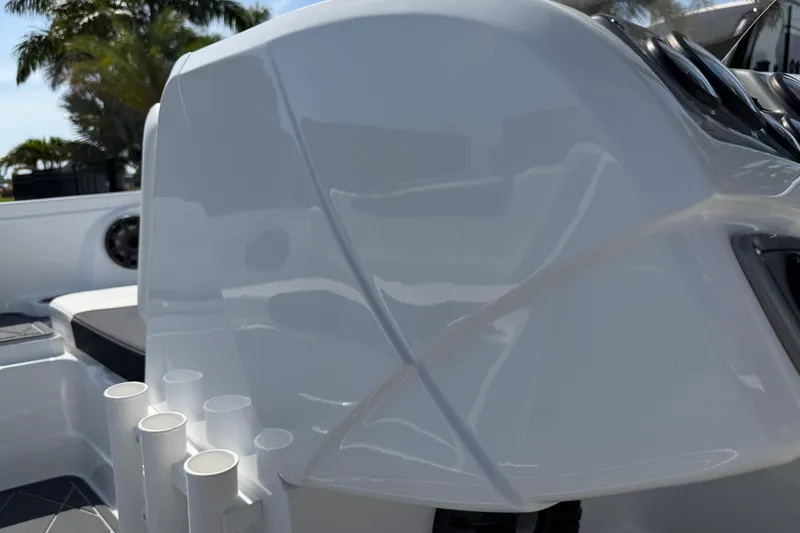 Slide: The Image of Close-up of a 2021 Tahoe 1950 boat's sleek white exterior with rod holders. - 52
