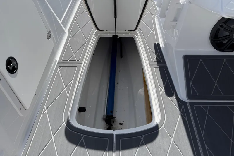 Slide: The Image of Open storage compartment on a 2021 Tahoe 1950 boat with gray flooring. - 83