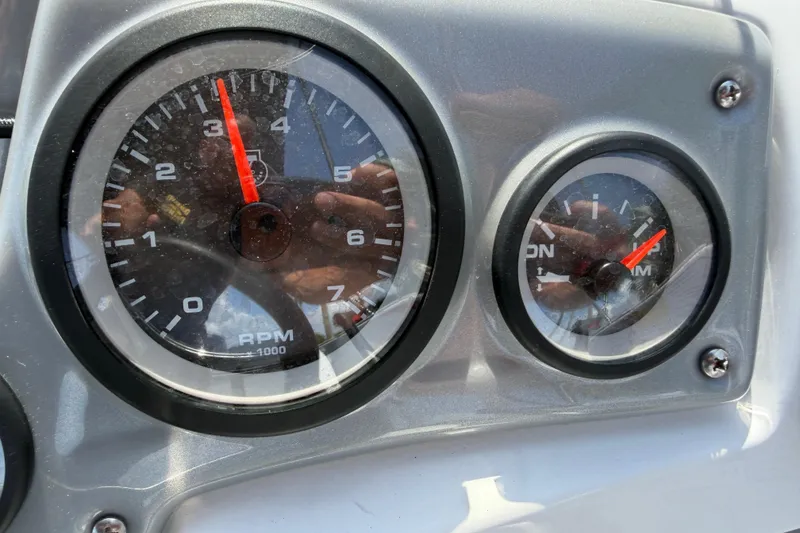 Slide: The Image of Close-up of Tahoe 1950 boat dashboard gauges, 2021 model, showing RPM and fuel indicators. - 45