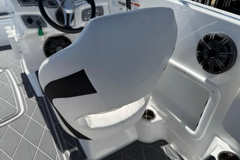 Slide: The Image of White captain's chair and dashboard in a 2021 Tahoe 1950 boat interior. - 88