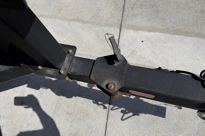 Slide: The Image of Trailer hitch of a 2021 Tahoe 1950 on concrete surface, shadow visible. - 26