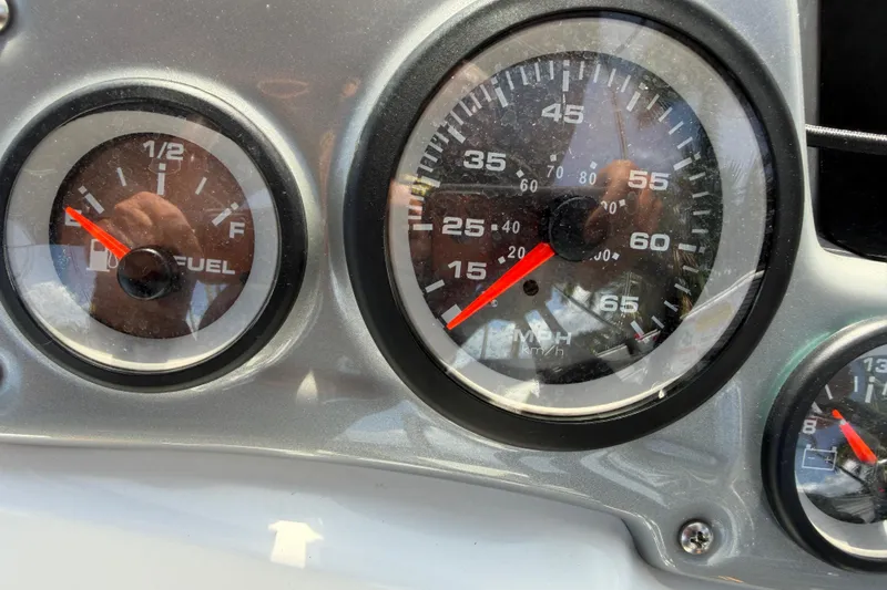 Slide: The Image of Dashboard of a 2021 Tahoe 1950 showing fuel and speed gauges. - 48