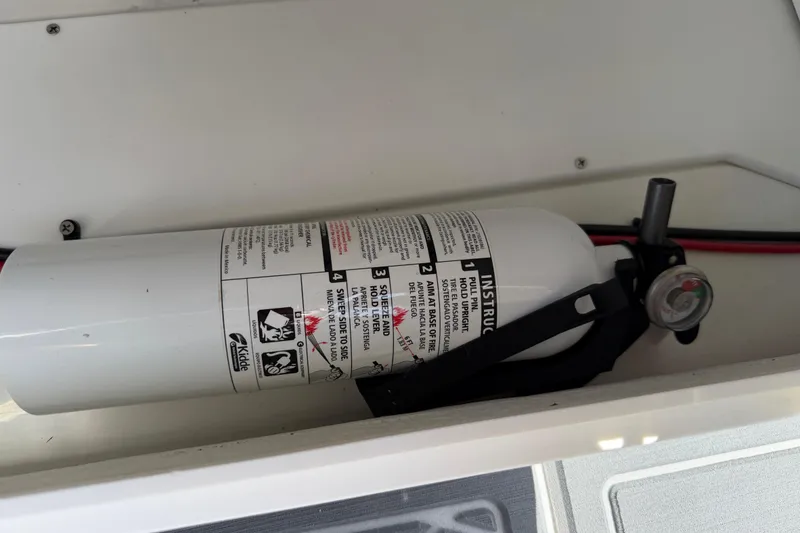 Slide: The Image of Fire extinguisher in Tahoe 1950 model boat, 2021, stored securely in compartment. - 80