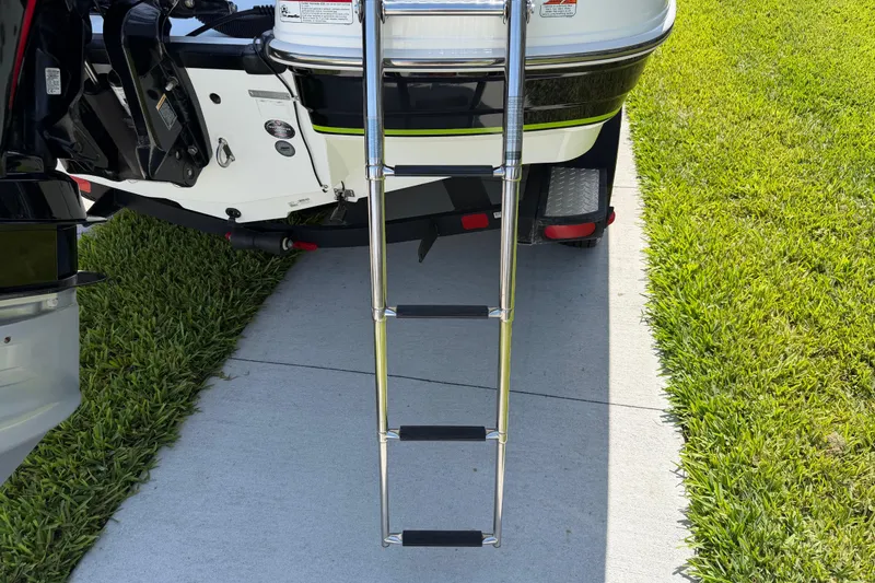 Slide: The Image of Boat ladder attached to a 2021 Tahoe 1950, parked on grass and pavement. - 35