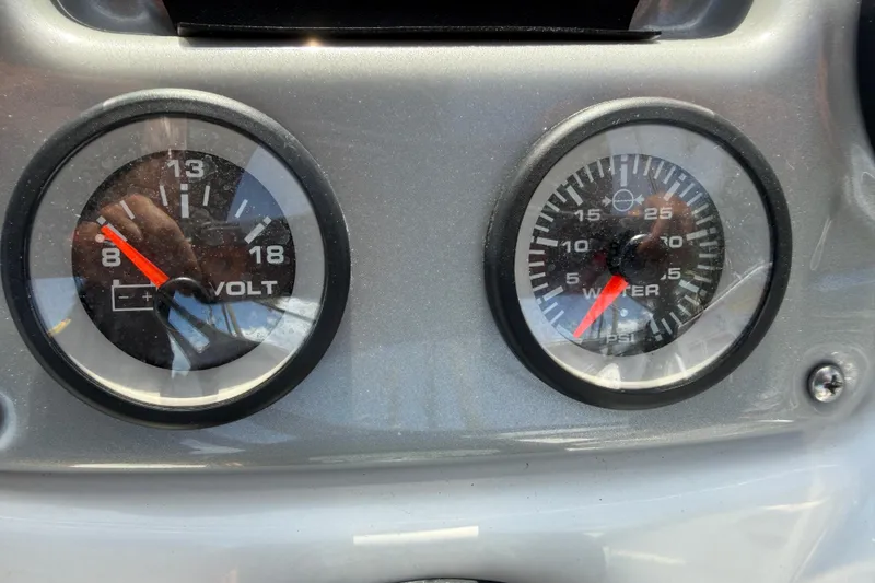Slide: The Image of Dashboard gauges of a 2021 Tahoe 1950 boat, showing voltage and water pressure. - 46