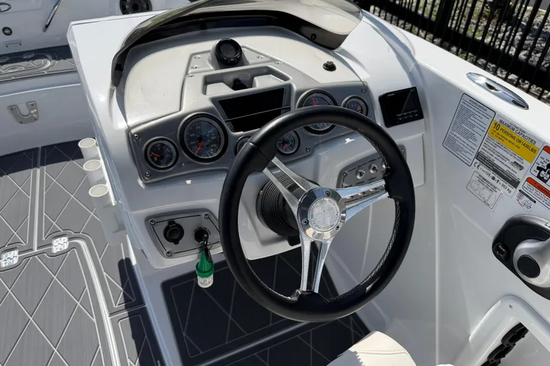 Slide: The Image of Steering console of a 2021 Tahoe 1950 boat with gauges and controls. - 40