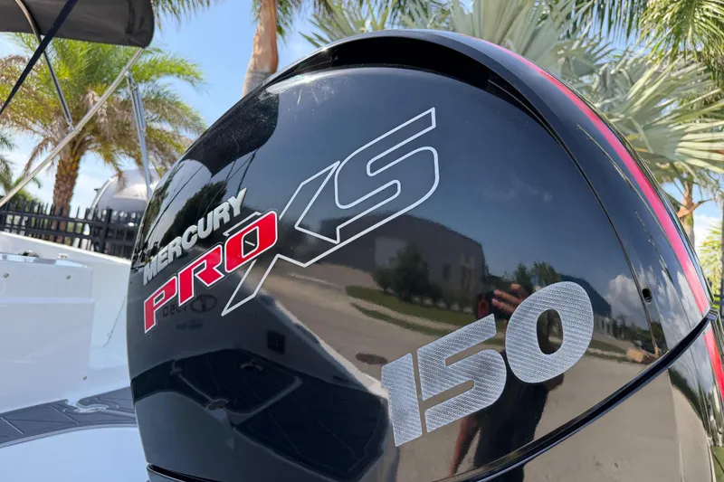 Slide: The Image of Mercury Pro XS 150 outboard motor on a 2021 Tahoe 1950 boat, surrounded by palm trees. - 8