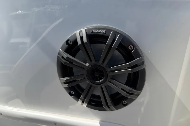 Slide: The Image of Kicker speaker on 2021 Tahoe 1950 boat, mounted on white surface. - 86