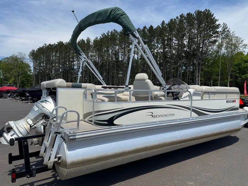 Slide: The Image of 2007 Bennington 2250RL pontoon boat parked in lot with trees. - 6