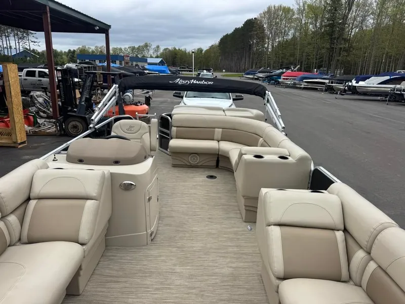 Slide: The Image of 2019 Misty Harbor A2285CR Adventure pontoon boat with beige seating outdoors. - 20
