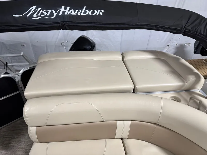 Slide: The Image of 2019 Misty Harbor A2285CR Adventure pontoon boat with beige cushioned seating. - 32