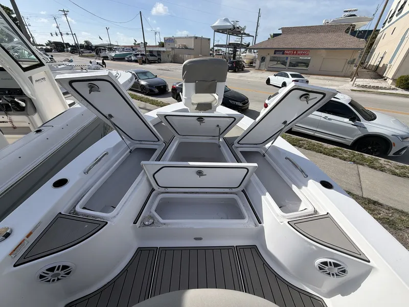 Slide: The Image of 2024 Sportsman Masters 227 Bay Boat with open storage compartments. - 13