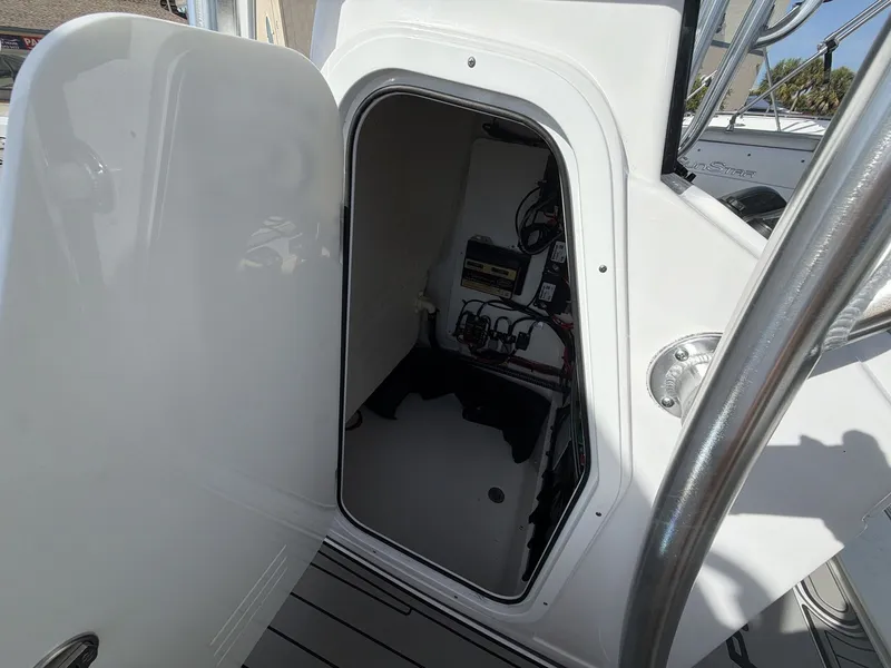 Slide: The Image of 2024 Sportsman Masters 227 Bay Boat storage compartment with electronics. - 4