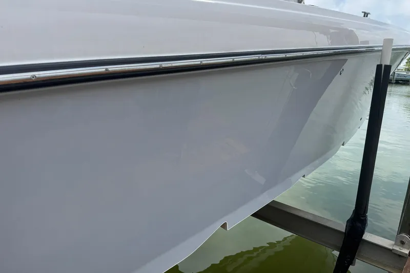 Slide: The Image of 2007 Spectre 34 boat hull on water, showcasing sleek design and polished finish. - 10