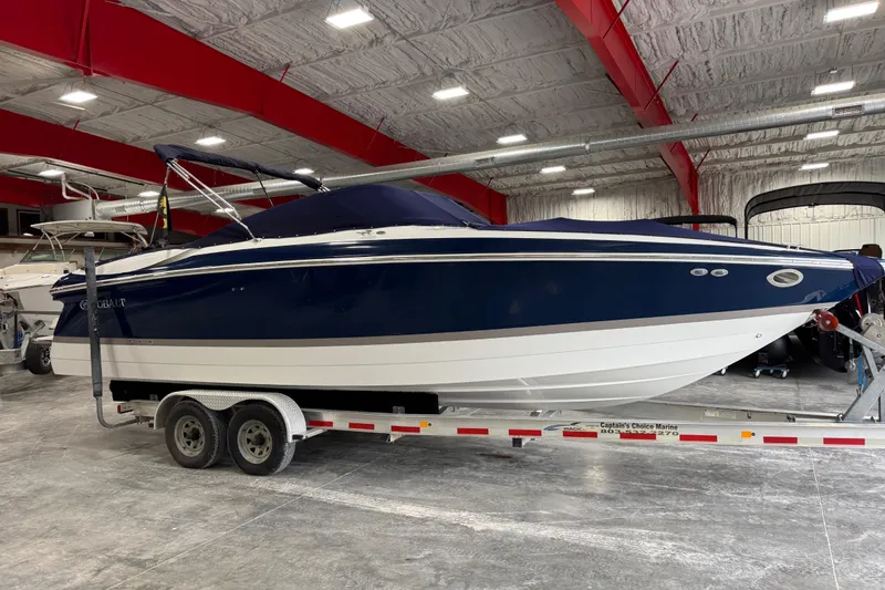 Slide: The Image of 2007 Cobalt 282 boat in a showroom, blue and white, on a trailer. - 16