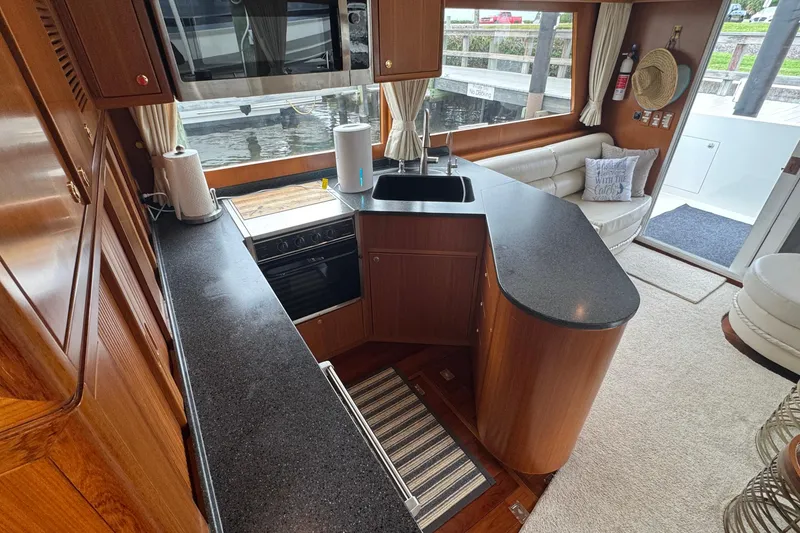 Slide: The Image of Luxurious kitchen interior of 2007 Jefferson Pilothouse 52 SE yacht with modern amenities. - 12