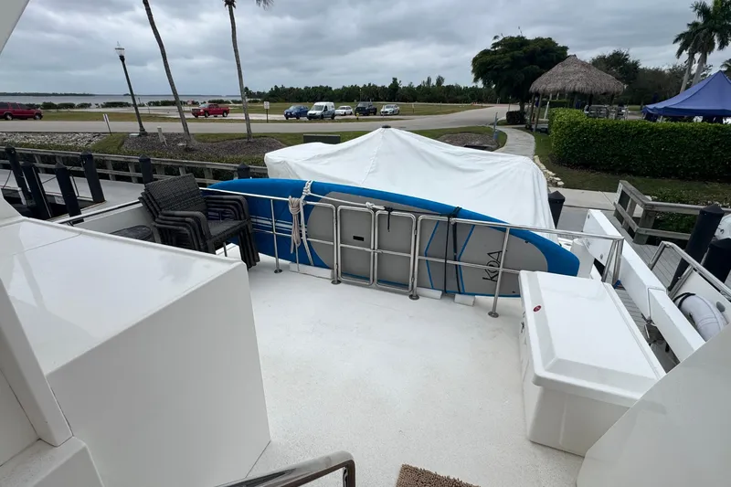 Slide: The Image of 2007 Jefferson Pilothouse 52 SE yacht deck with paddleboard and outdoor seating. - 15